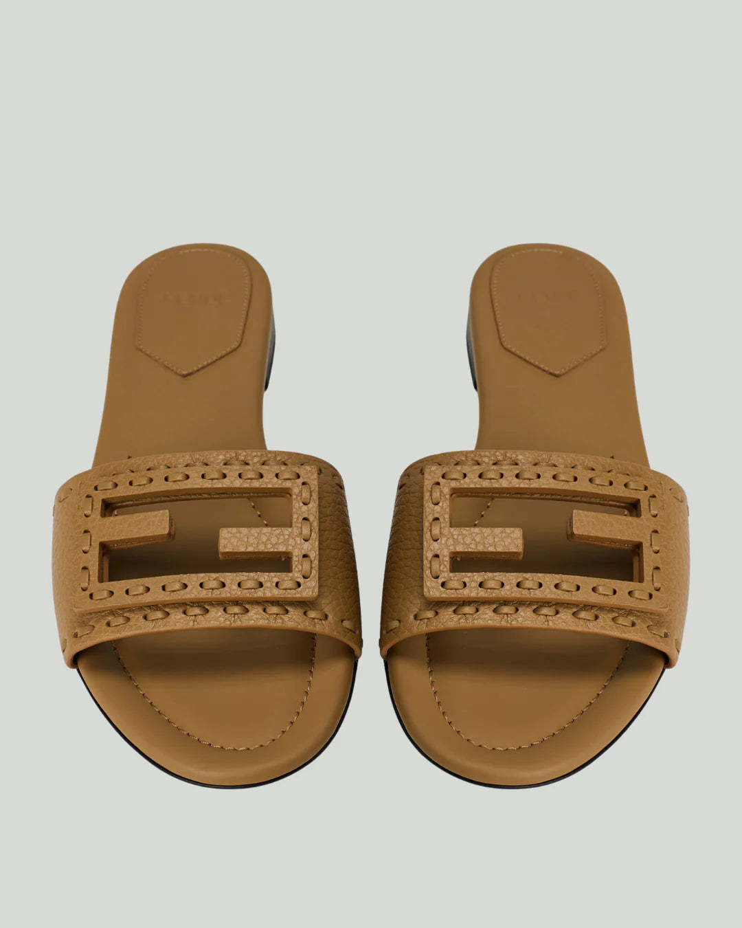 Fendi Baguette Leather Slide Sandals in camel tan, top view showing FF logo strap with whipstitch detailing